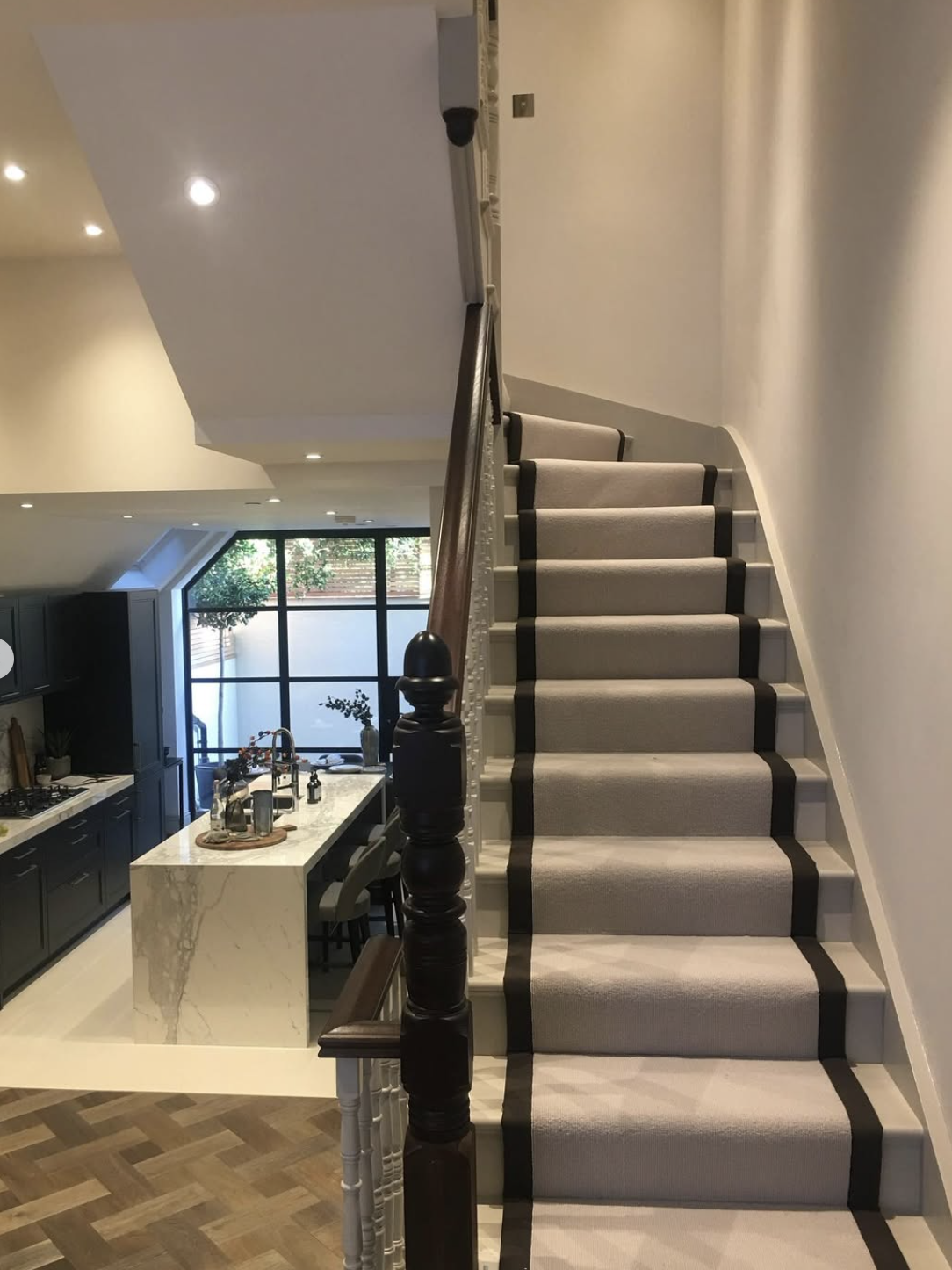Freshly painted staircase and kitchen in a London home by A1 Decorating
